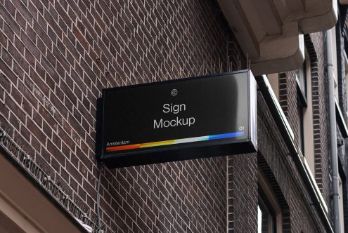 Rectangular signboard mockup hanging on a building wall with urban brick texture background for outdoor advertising design display.